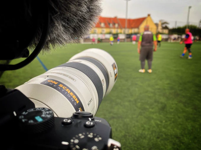 A camera capturing walking football players on an artificial pitch at KGV playing fields in Guernsey.