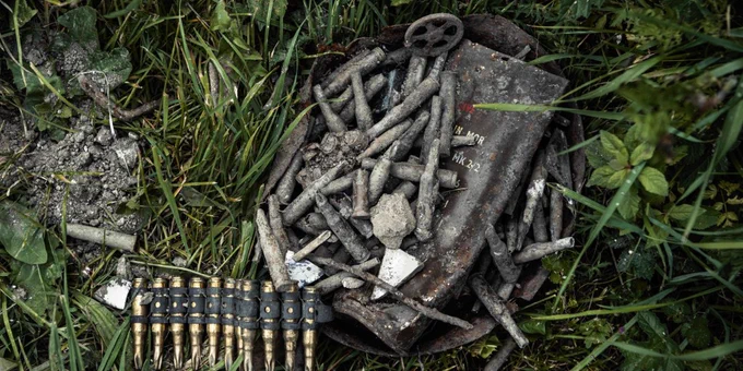 Archaeological finds- old, rusty bullets and shell casings lay nestled on grass in the lost village of Imber