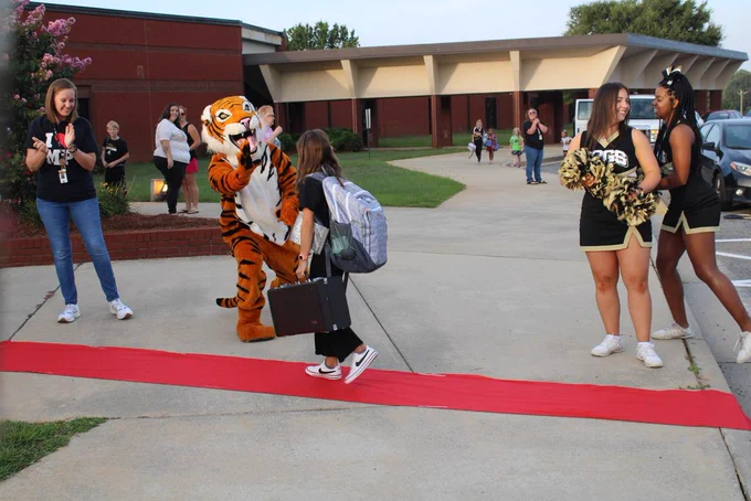 Emery getting a high five from Sammy the Tiger