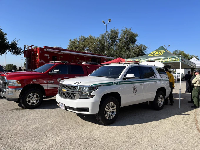 A white USDA Forest Service vehicle and a red Los Angeles County Fire vehicle.