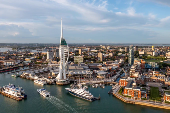 The Spinnaker Tower with boats sailing by.