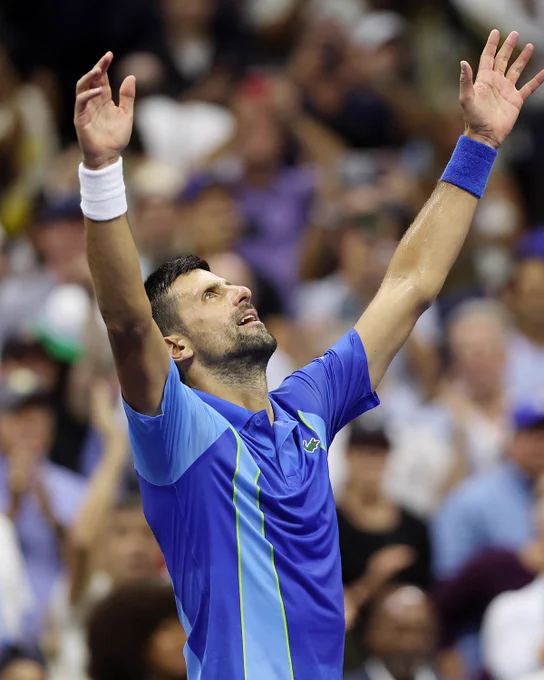 Novak Djokovic with his hands in the air after winning the US Open title. 