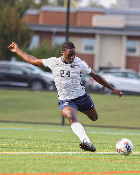 Student athlete kicking a soccer ball.