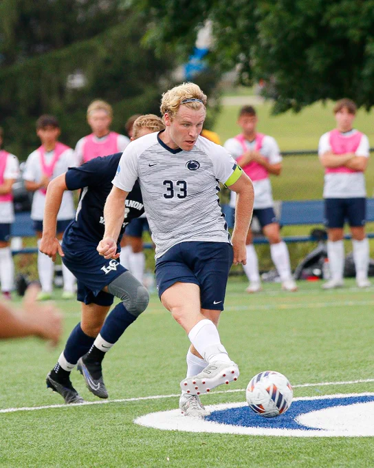 Student athlete dribbling a soccer ball.