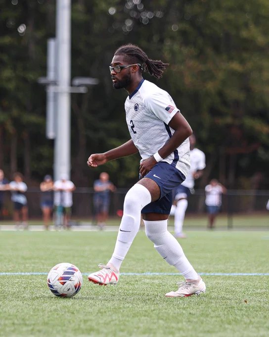Student athlete dribbling a soccer ball.