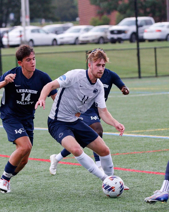 Student athlete dribbling a soccer ball.