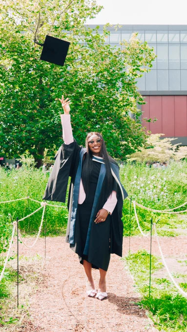 Graduating students throwing a graduation hat.
