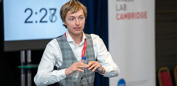A head and shoulders shot of alumnus Robert Kunzmann, presenting on stage.