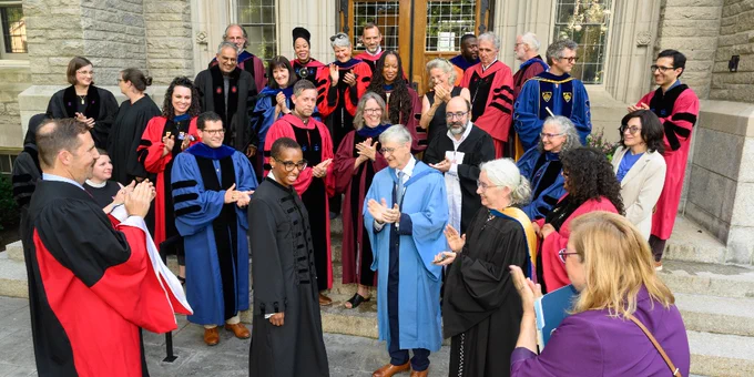 Faculty gather outside Swartz Hall and applaud President Gay's appointment.