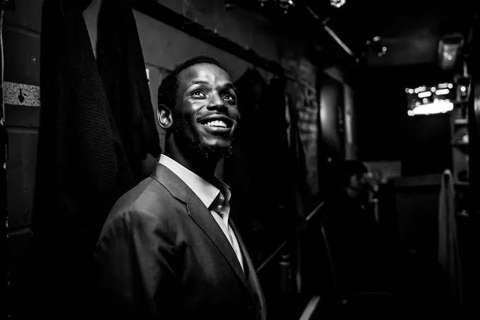 One actor smiles and looks up backstage