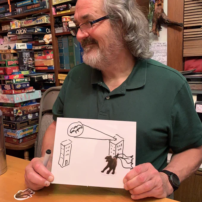 Tim smiling with the image he drew while playing The Cat Game
