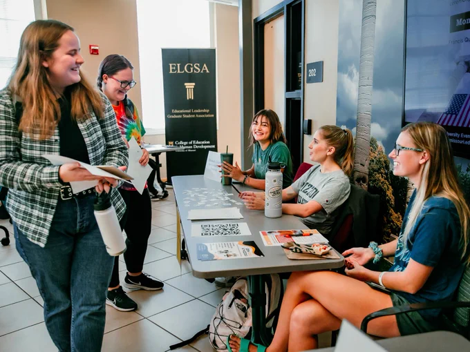 Students browsing at a table
