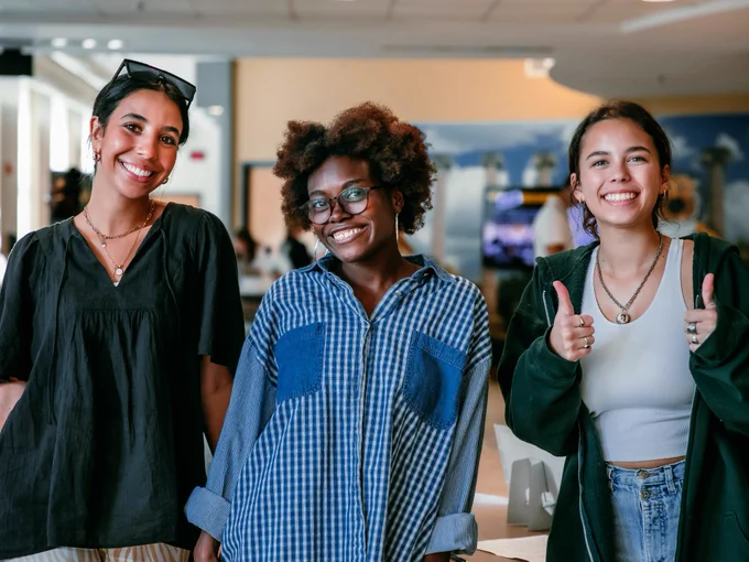 Three students smiling