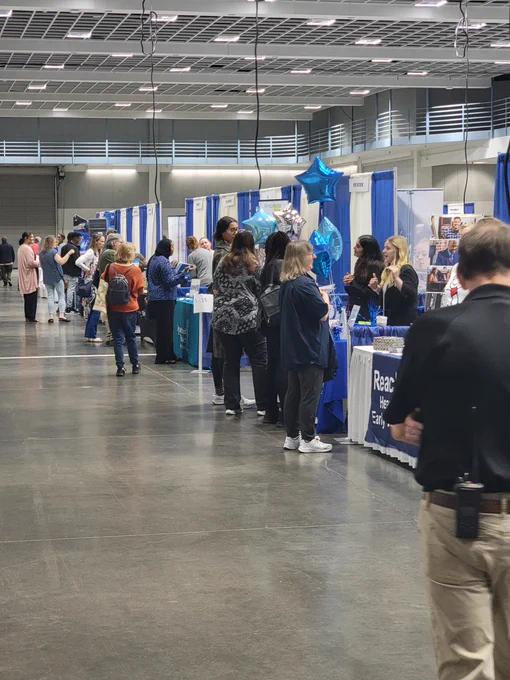A group of job seekers walk and talk with various employers at the St. Cloud Area Career Fair. 