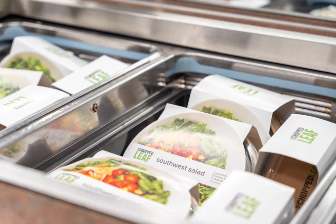 A display filled with pre-packaged salads