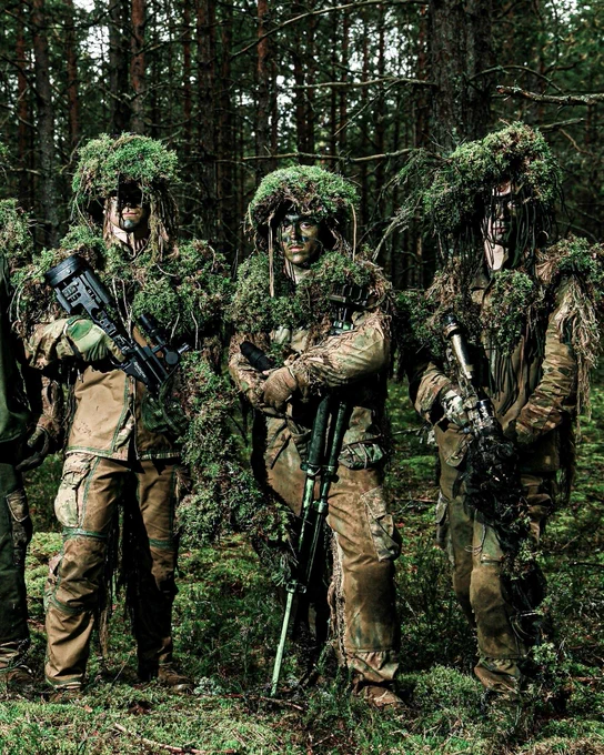 Camouflaged U.S. Army soldiers in the woods during sniper training at Camp Adazi. Photo by: U.S. Army - Staff Sgt. Oscar Gollaz.
