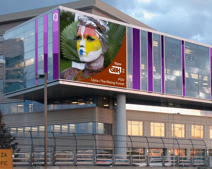 GBH mural depicting the colorfully painted face of Uýra, an Indigenous visual artist and the subject of a new POV documentary.