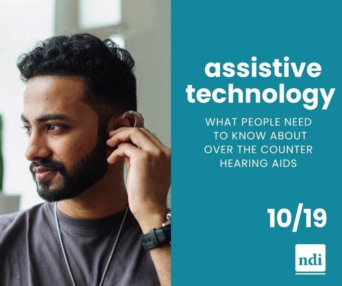 Teal blue graphic with white text reading: Assistive technology, What people need to know about over the counter hearing aids. 10/19. To the left is a photo of a man putting on a hearing aid. In the bottom right corner is the NDI logo. 