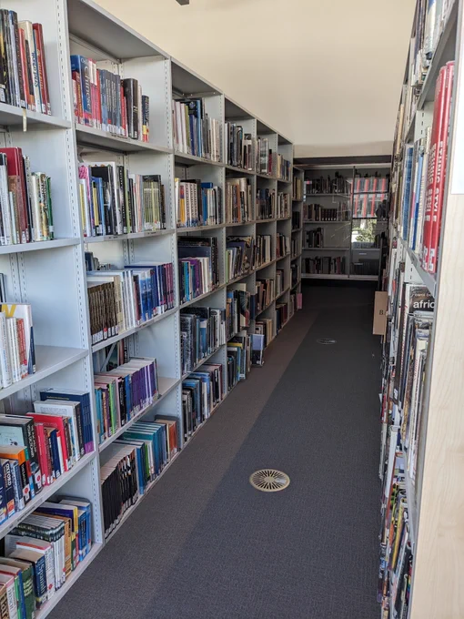 An image of two book shelves parallel to one another.  