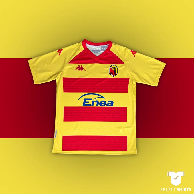 Jagiellonia's yellow home shirt, with four red hoops across the chest and blue 'Enea' sponsor logo.