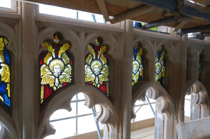 A window at Rotherham Minster. Scaffolding can be seen at the top of the frame. In the centre, clear and stained glass can be seen within window tracery. 
Photo credit: Walker Cunnington Architects