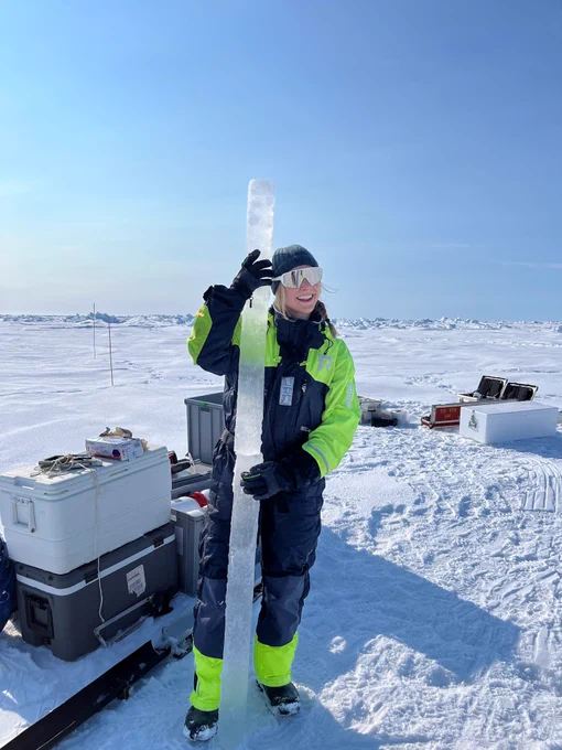 
Megan is in the Fram Strait during the second campaign for the Sustainable Development of the Arctic Ocean Project aboard R/V Kronprins Haakon in June 2023. She is holding an ice core which is taller than herself, with gear stacked around her.
