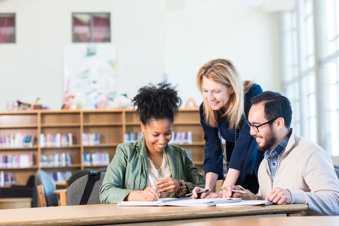 Three people in a library