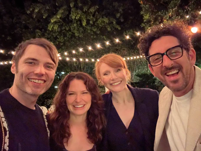 Shanah Tovah from (left to right), Seth Gabel, Katie Lowes, BDH, and Adam Shapiro who smile for a group photo after their Yom Kippur meal. The long-time friends stand together on an outdoor patio decorated with twinkly lights at the Winklers’ house.