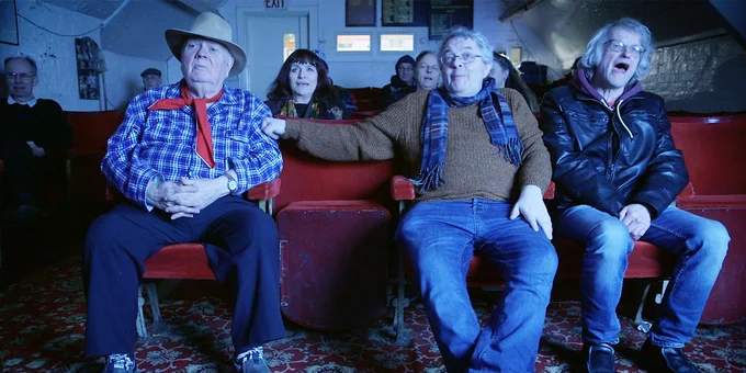 The Bradford Movie Makers enjoy a film screening in a scene from A BUNCH OF AMATEURS