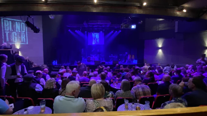 The Point auditorium space full with a seated crowd