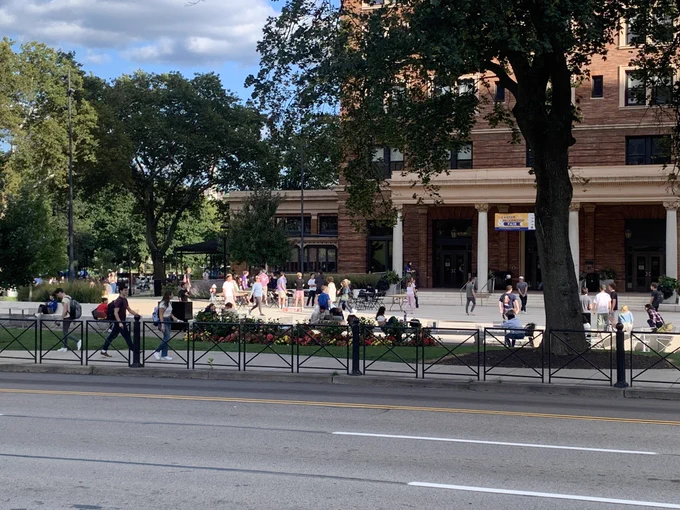 Students reading and playing on a newer plaza converted from a shuttle parking loop at Pitt