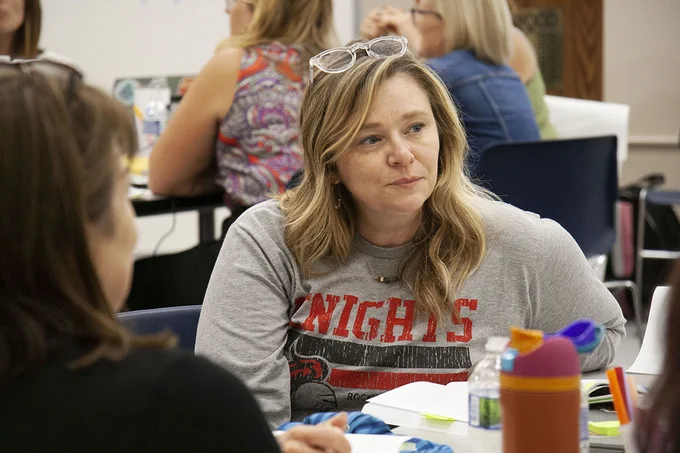 Rockwood Valley Middle teacher Angie Ortinau listens to a colleague during a discussion session.