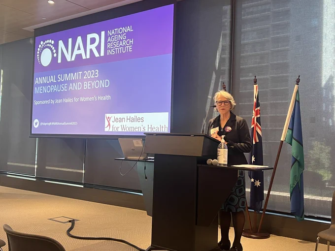 A woman speaking at a lectern