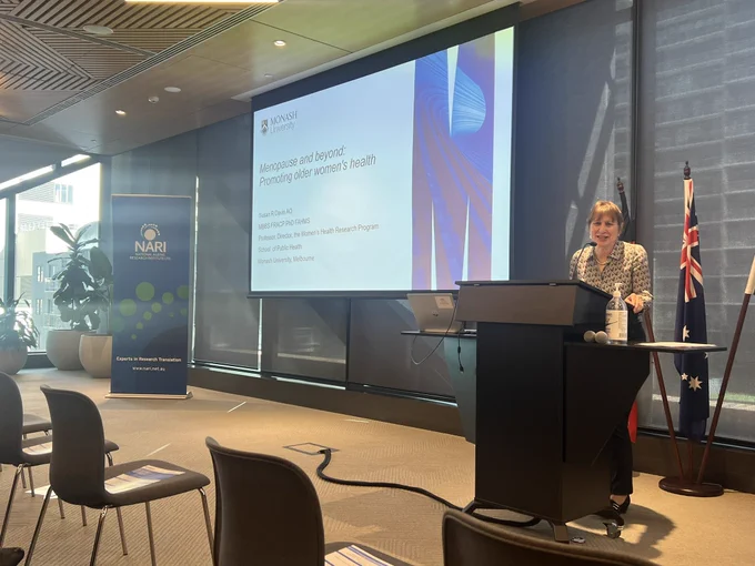 A woman speaking at a lectern