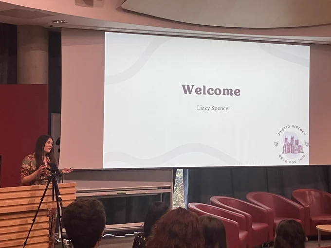 Lizzy Spencer presenting in front of a slide show saying ‘welcome’
