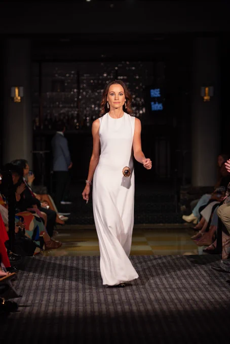 Emily in a white gown on the runway