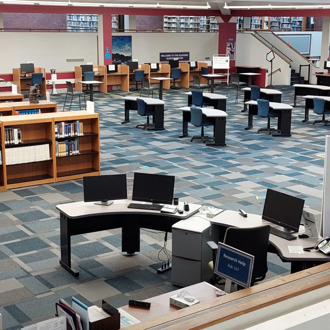Library with desks, chairs and books.