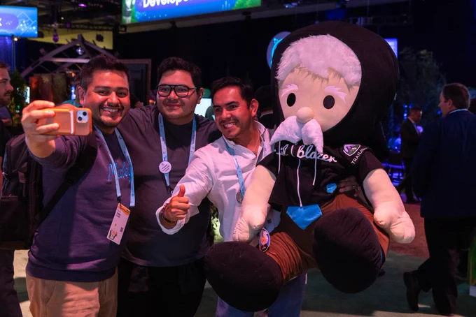 Attendees taking a selfie with the Einstein plushie.