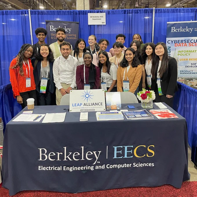 17 Berkeley EECS students huddle together for a group photo at the Berkeley EECS both at Tapia Conference 2023.