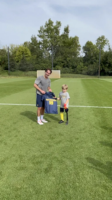 Bode Saul presenting Jaxon with his Jersey