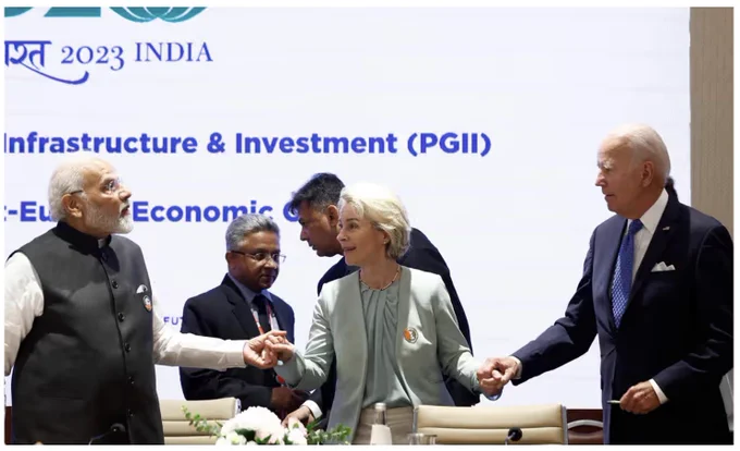 Photograph: Evelyn Hockstein/AFP/Getty Images: Modi, von der Leyen, Biden holding hands with two men and G20 screen behind them 