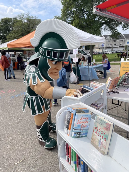 Sparty selects a book from the Library on the Go.