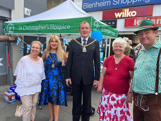 Photo of the Mayor and Mayoress at the event in front of St Christopher's stall.
