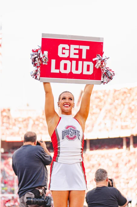 Ohio State Dancer at Buckeye Football Game holding a Get Loud sign