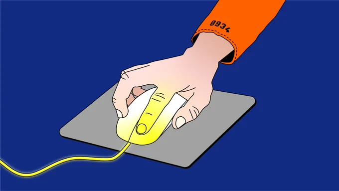 A hand moving a computer mouse. The mouse shines slightly yellowish on the front, as does the cable and the finger using it. The arm of the user is covered in an orange sleeve with a number on it.