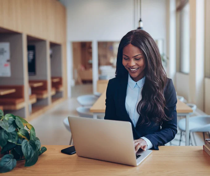 professional woman smiling at laptop