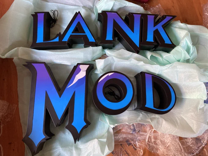 Several letters are arranged on the floor to spell out "lank mod."