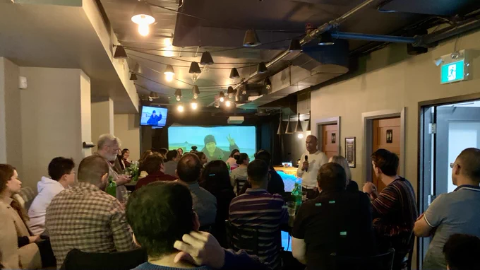 Chris Henderson speaking to a crowd at CapCHI. 