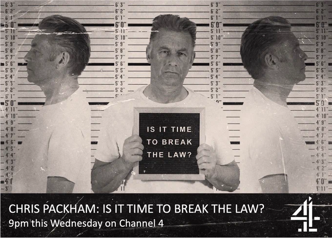Mug shot of Chris Packham, he's holding a sign saying is it time to break the law?