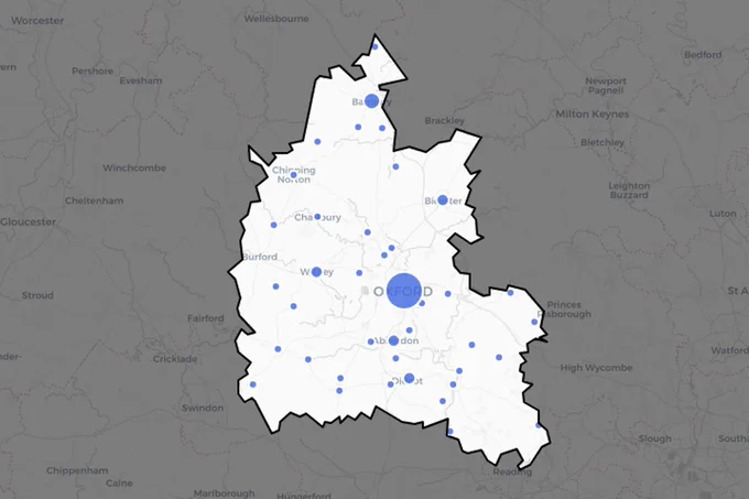 A screenshot of an interactive leaflet map, showing towns/cities in Oxfordshire, UK. The map outside of Oxfordshire has been shaded out to de-emphasise it.